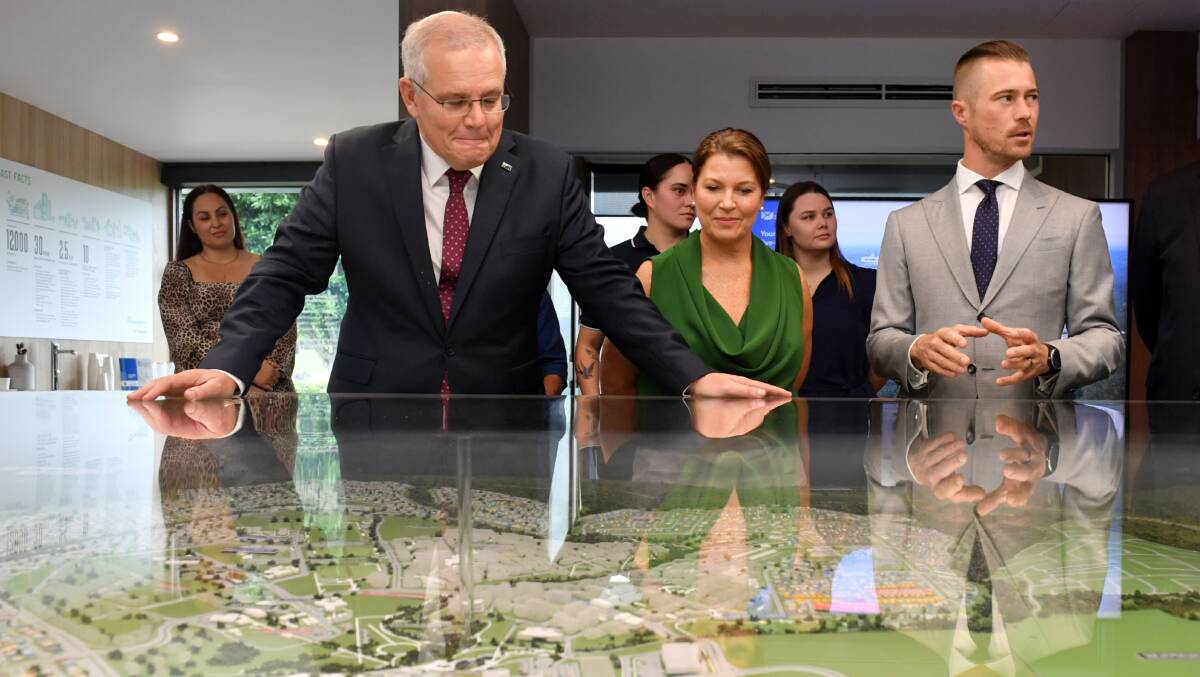 Prime Minister Scott Morrison, Jenny Morrison and Liberal candidate for Blair Sam Biggins at Springfield Rise Display Village. Picture: AAP