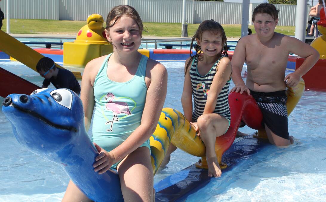 Pippa, Sarah and Will Moxey from Forbes have fun playing in the children's waterpark during a stopover in Moree on their way home from the Gold Coast.