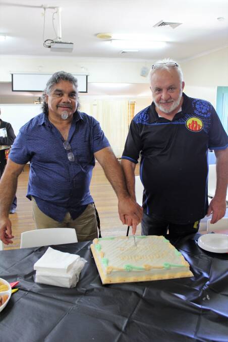 Ricky Werribone and Peter Gander cut the graduation cake, made by Moree Bakehouse.