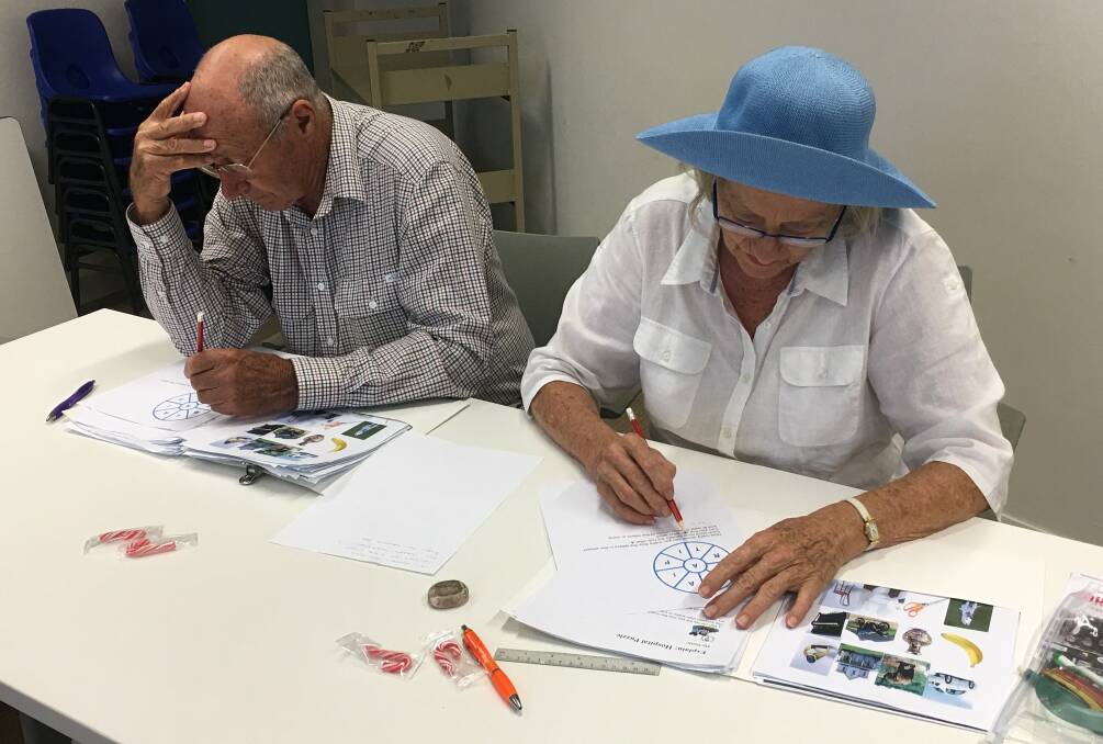 Rens and Merri Gill participate in brain training at Moree Community Library. Photo: contributed