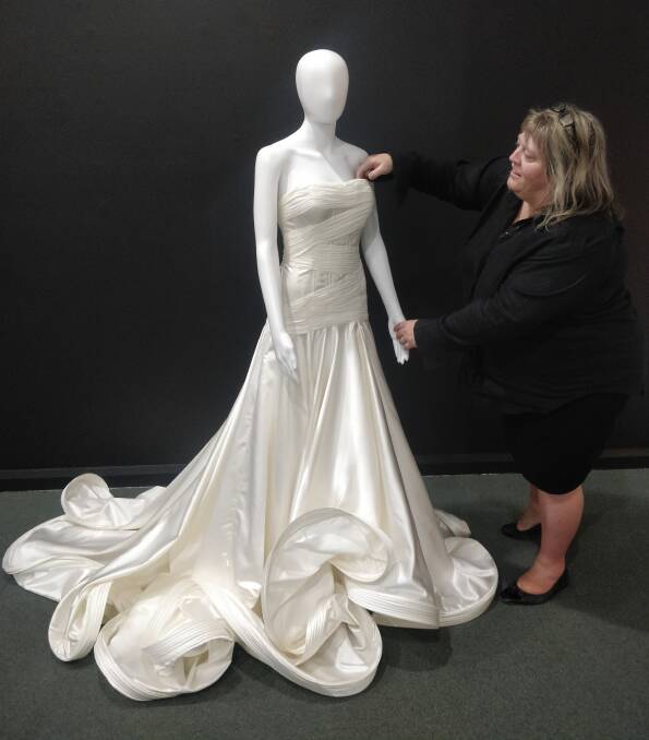 Moree dressmaker Melinda O'Donoghue prepares one of her gorgeous gowns, ahead of her very first exhibition, which opens at BAMM this Friday. Photo: BAMM