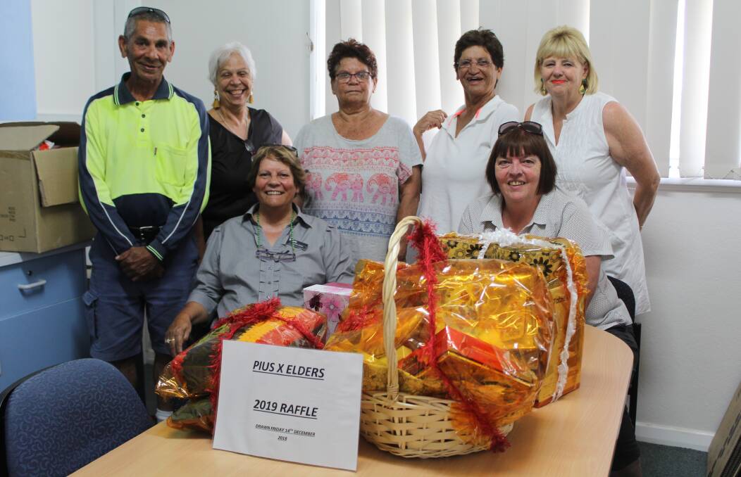 (Back) Bruce Copeland, Pius X CEO Donna Taylor, Zona Moore, Wendy Craigie, Annabelle Simpson, (front) Denise Jenkins and Ros Laws with the raffle prizes.