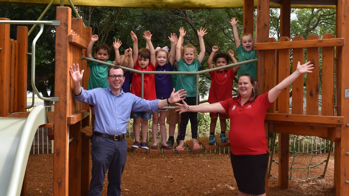 Northern Tablelands MP Adam Marshall and Grace Lutheran Preschool service leader Megan Fleming celebrate the news of funding from the NSW government to expand the preschool with some of the excited students.