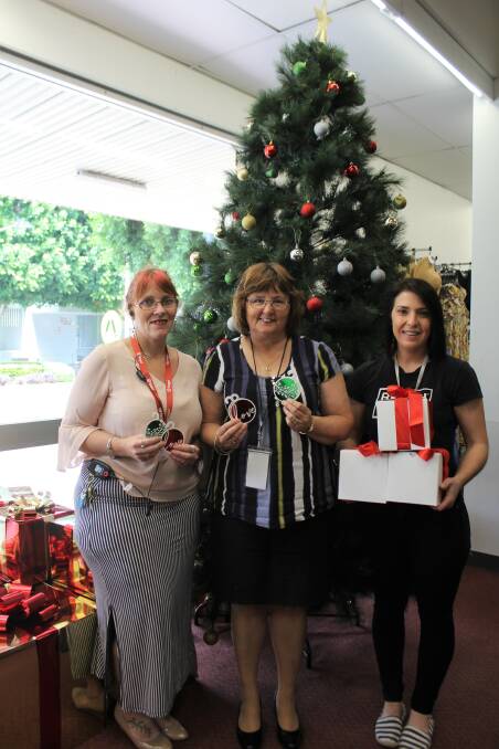 GIFT OF GIVING: Target Moree manager Emma O'Hern, Moree Uniting Church volunteer Karen Kong and Moree Family Support's Marie O'Neill encourage shoppers to purchase a $2 gift tag or $3 gift box to support locals in need.