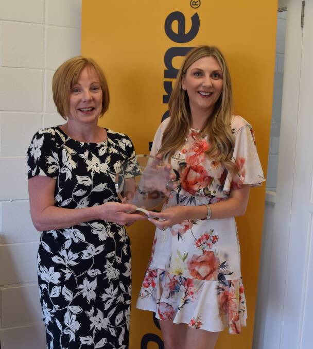 Katrina Tarrant (right) of Raine and Horne Corporate Sydney office presents the 30 years of service award to principal of the Moree office, Kelly Atkins.