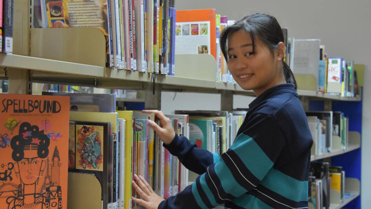FULL OF KNOWLEDGE: Moree Secondary College year 10 student Patty Zou experiences what it's like to be a librarian