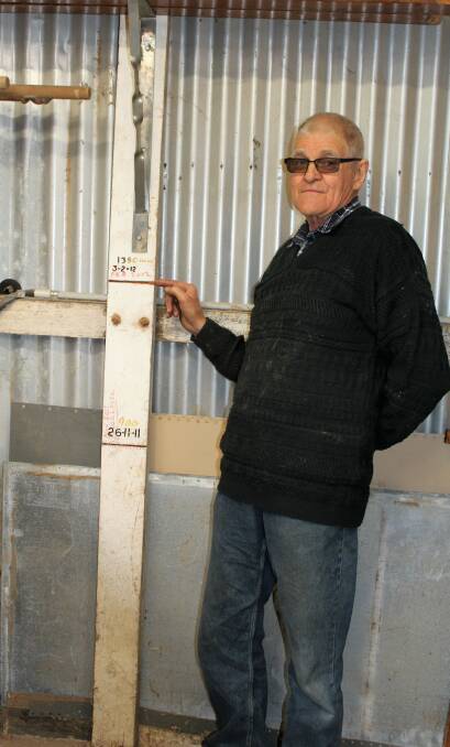 Moree Men's Shed president Peter Sampson shows the height of the water during the 2012 flood.