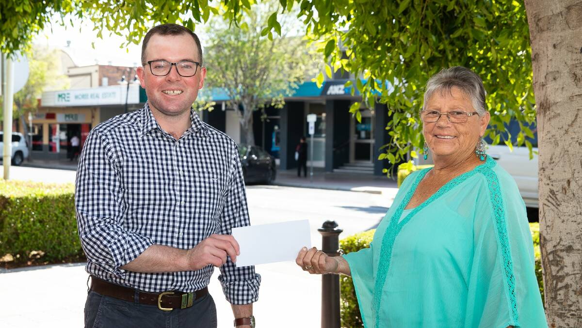 Northern Tablelands MP Adam Marshall presents Garah Community Fundraiser President Maureen Ledingham with a cheque for $25,000 to support local people needing to travel away for medical treatment. Photo: supplied