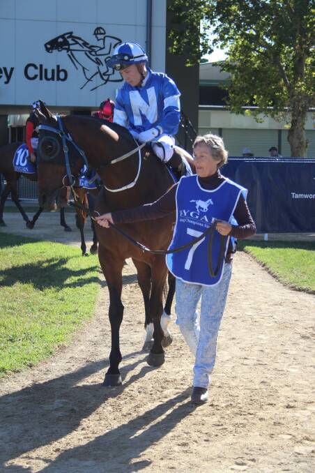 Moree gelding Rockatorio roared into Moree Picnic Cup contention by winning at Tamworth on Tuesday. Here he parades with owner Barb Davis, the strapper, and jockey Josh Oliver on board. Photo: Rachel Young, Tamworth Jockey Club. 