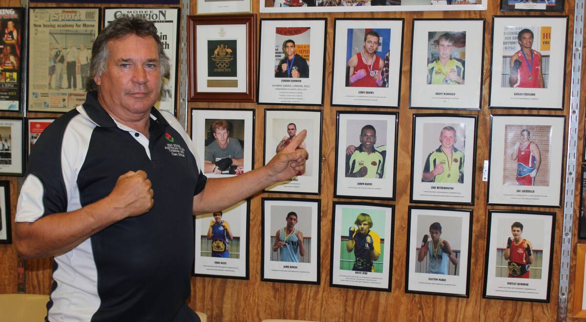 MENTOR: Danny Cheetham pictured with photos of some of the champion boxers he's coached over the years which hang with pride on the wall of the Moree Boxing Academy.