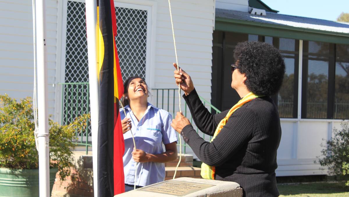 Moree Secondary College student Shanika Hippi and local elder Denise Webb raised the flag at Pius X during last year's Sorry Day event.