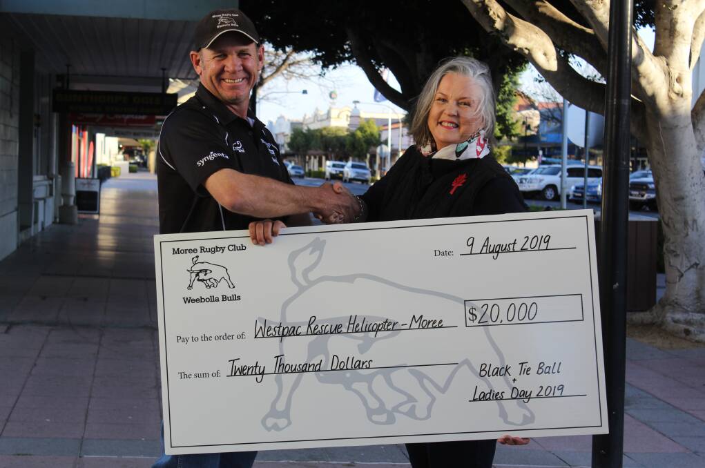 Moree Rugby Union Club president Paul King presents the cheque to WRHS Moree Support Group president Jane Rohde.