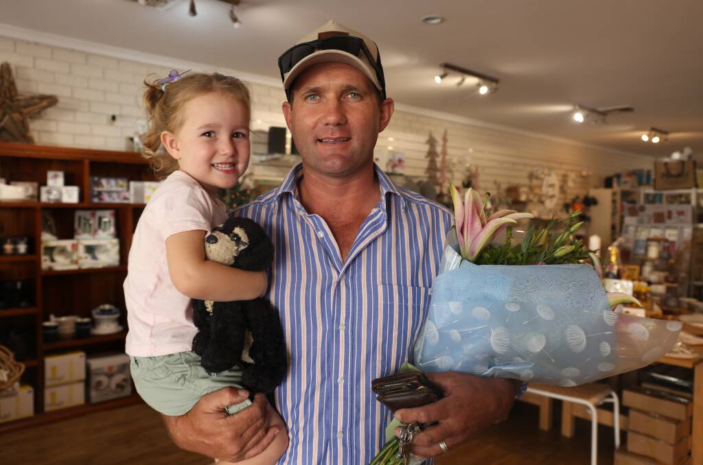 Stephen Ward, and daughter Letti, pictured purchasing flowers from A Tasty Surprise to celebrate the birth of their son and brother, Sonny Ward, who was born on December 30. Photo: Georgina Poole