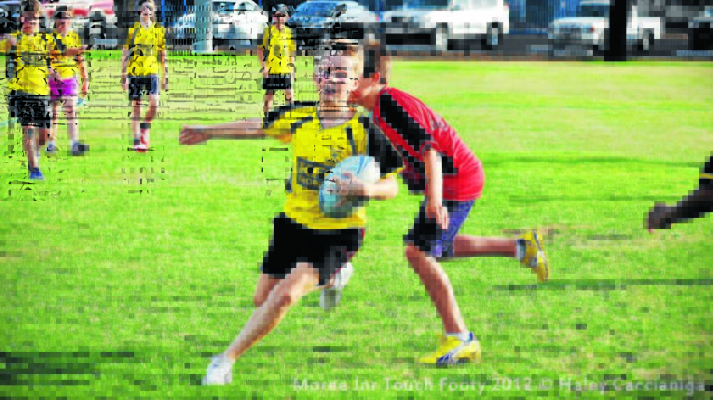 Braith Rodhe running with the ball during the 2012 junior touch football competition.