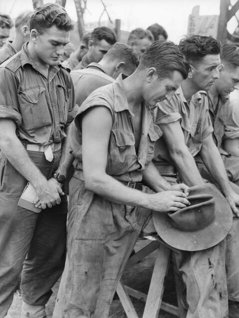 Members of the 7th Division and Ran Commandos at prayer during the thanksgiving service held in the Salvation Army hut in Balikpapan, Borneo on Victory in the Pacific Day on August 15, 1945. Photo: Australian War Memorial