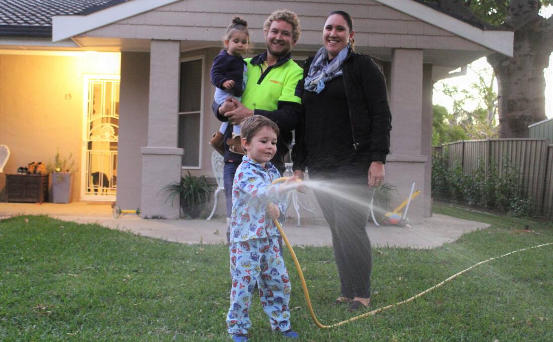 WELCOME NEWS: Jason Moss and Ashleigh Cooke, pictured with children Amity (one) and Andy (three), were thrilled to find out they would get a 50 per cent rebate on their next water bill. Photo: Sophie Harris