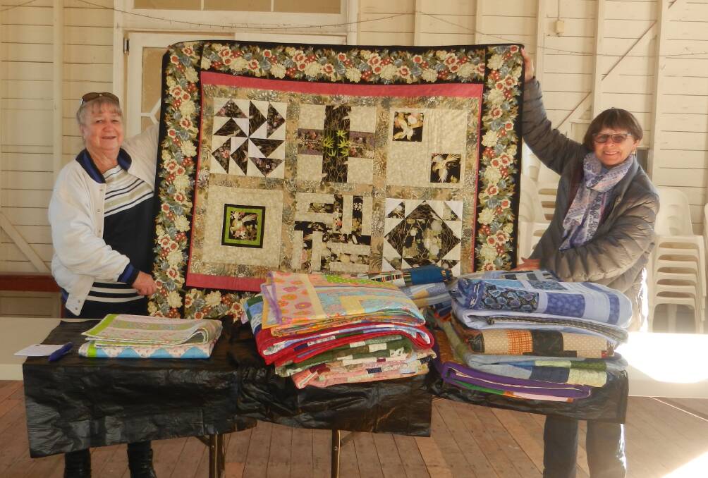 Weemelah CWA president Dawn Toohey and Bev Burton from Corner Quilters with the donated quilts. Photo: contributed