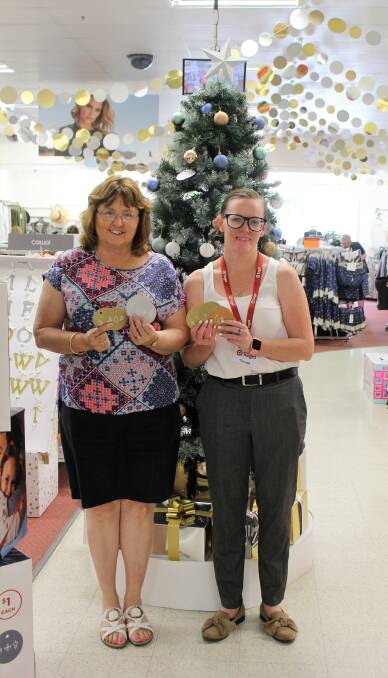 Moree Uniting Church volunteer Karen Kong and Target Moree assistant store manager Tamara Gallagher encourage shoppers to purchase a $1 bauble to make Christmas a little brighter for those in need this year.