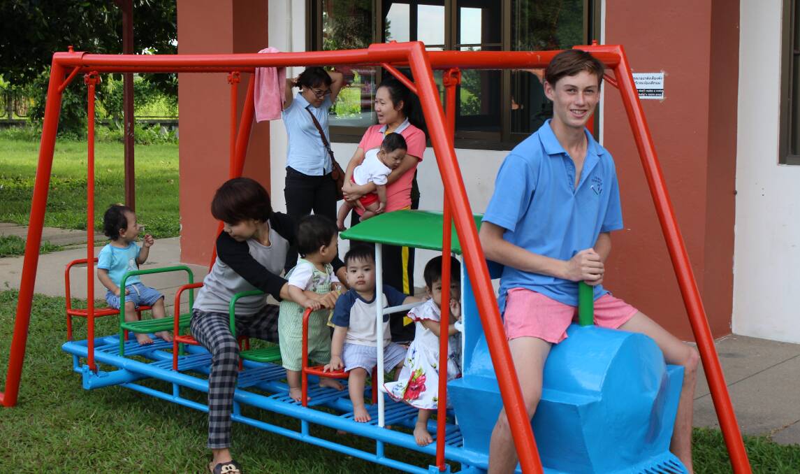 GIVING BACK: Bailey Bourke with HIV orphans from the Agape Home in Chiang Mai, Thailand.