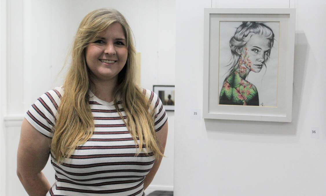 WINNER: Madelaine Russell pictured with her People's Choice Prize-winning portrait, 'Out of the Woods'.
