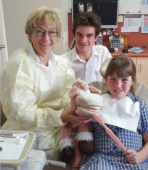 Retiring Moree Hospital dental clinic therapist Rita Rodgers with Edward and Clare Montgomery on her last day of work. Photo: Haley Caccianiga
