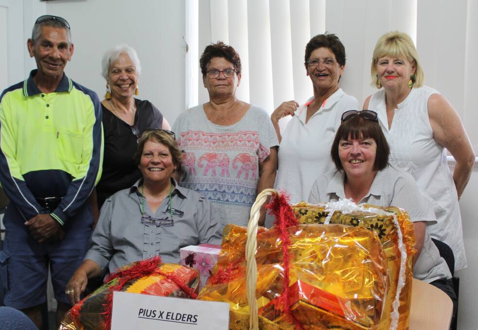 (Back) Bruce Copeland, Pius X CEO Donna Taylor, Zona Moore, Wendy Craigie, Annabelle Simpson, (front) Denise Jenkins and Ros Laws with last year's raffle prizes.