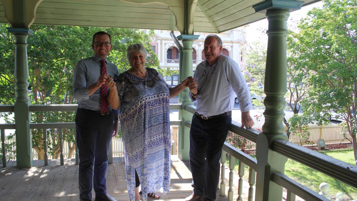 HANDOVER: Northern Tablelands MP Adam Marshall takes the $1 payment from Moree Plains Shire Council Mayor Katrina Humphries and Moree and District Historical Society president Stephen Ritchie at the former Crown Lands building at 40 Frome Street.