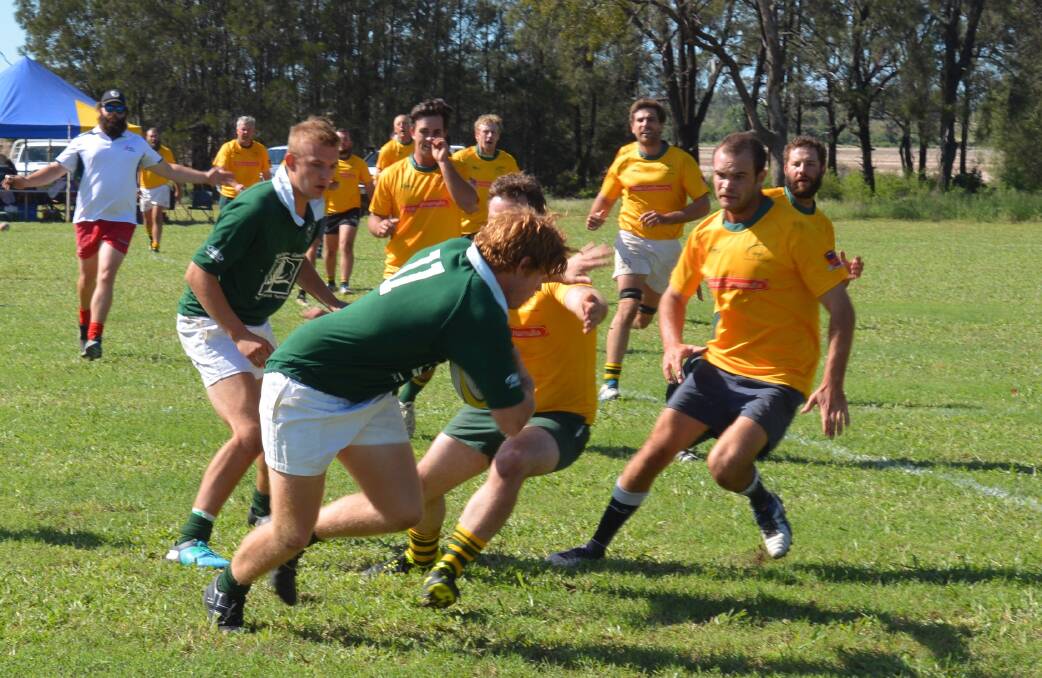 RUGBY SHOWCASE: Croppa Creek Crows' Clint Miller palms away the Cunamulla forward pack during last year's gala day. Photo: Grace Cobb