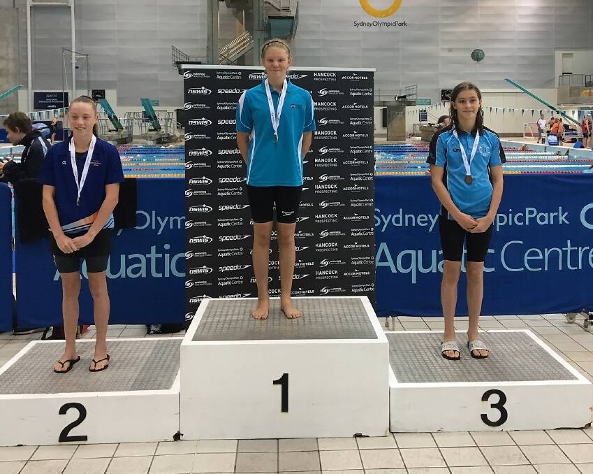 PROMISING YEAR AHEAD: Moree's Ava Macey on the podium after winning the 12 years and under 100m breaststroke at 2020 NSW Country Championships. Photo: supplied