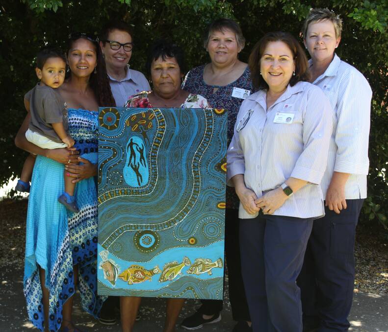 Moree artist Val Pitt won the Moree District Health Service competition. She is pictured with her winning artwork (centre) and her great grandson Isaiah Priestley, granddaughter Tara Priestley, Moree Hospital acute health service manager Bronwyn Cosh, Aboriginal Health coordinator Candice Dahlstrom, Community Health manager Anne Lemmon and Community Health nurse unit manager Lee Clissold.