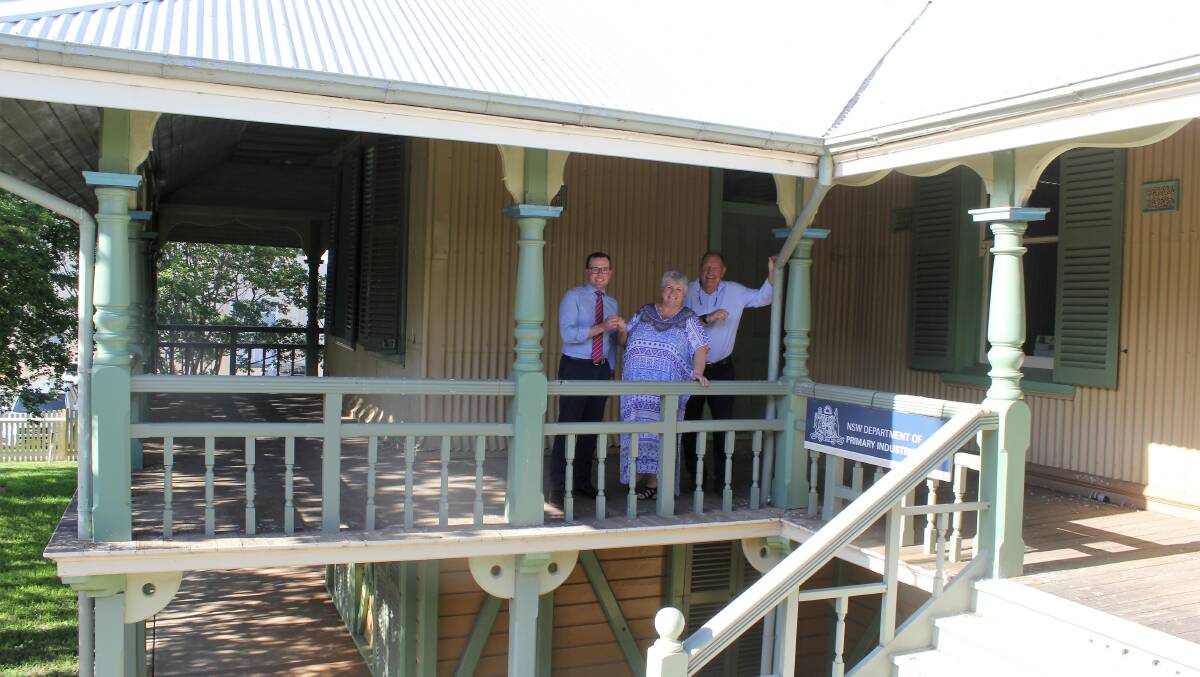 HANDOVER: Northern Tablelands MP Adam Marshall takes the $1 payment from Moree Plains Shire Council Mayor Katrina Humphries and Moree and District Historical Society president Stephen Ritchie at the former Crown Lands building.