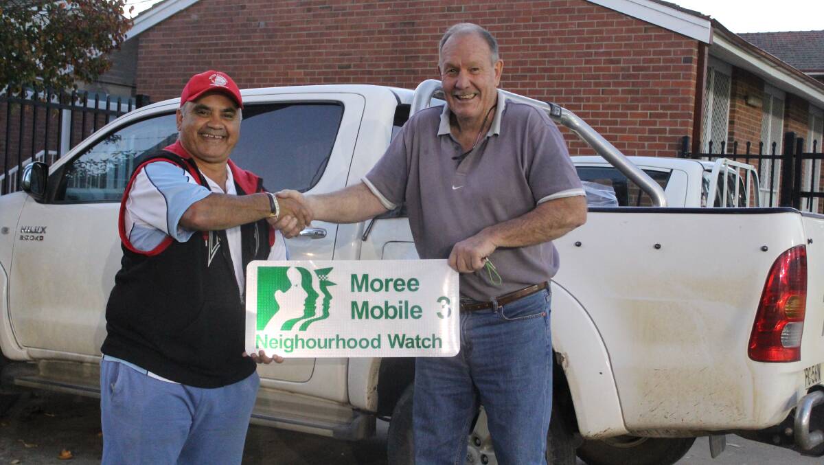 THANKFUL: Moree Mobile Neighbourhood Watch members Chris Binge and Stephen Ritchie with the magnetic signs which were donated to the group by Moree Signs.