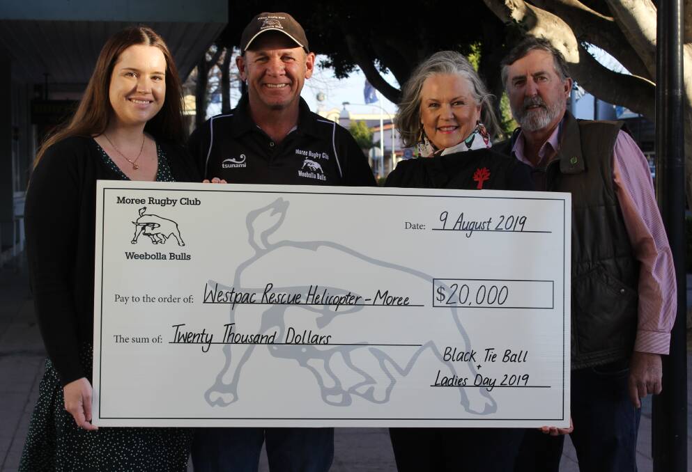 Moree Bulls Ladies Day committee member Nicole Youngberry and club president Paul King present the cheque for $20,000 to Westpac Rescue Helicopter Service Moree Support Group's Jane and Phil Rohde.