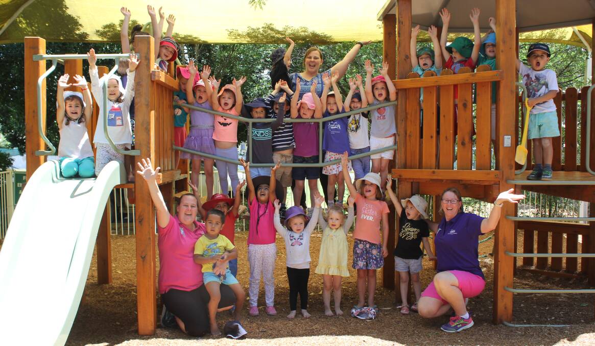 Grace Lutheran Preschool service leader Megan Fleming (bottom left) pictured with staff and students in 2017 when they found out they had successfully gained funding to expand.