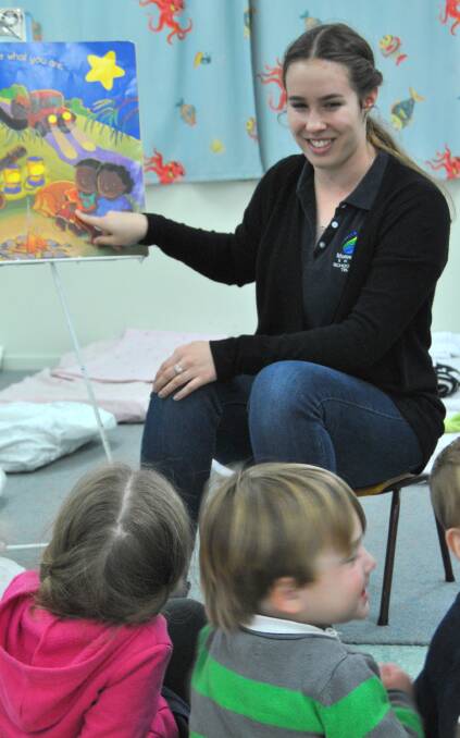STORY-TIME: Surrounded by the children at Gwydir Daycare and Preschool, school-based trainee Emily Cosgrove shares stories and songs.