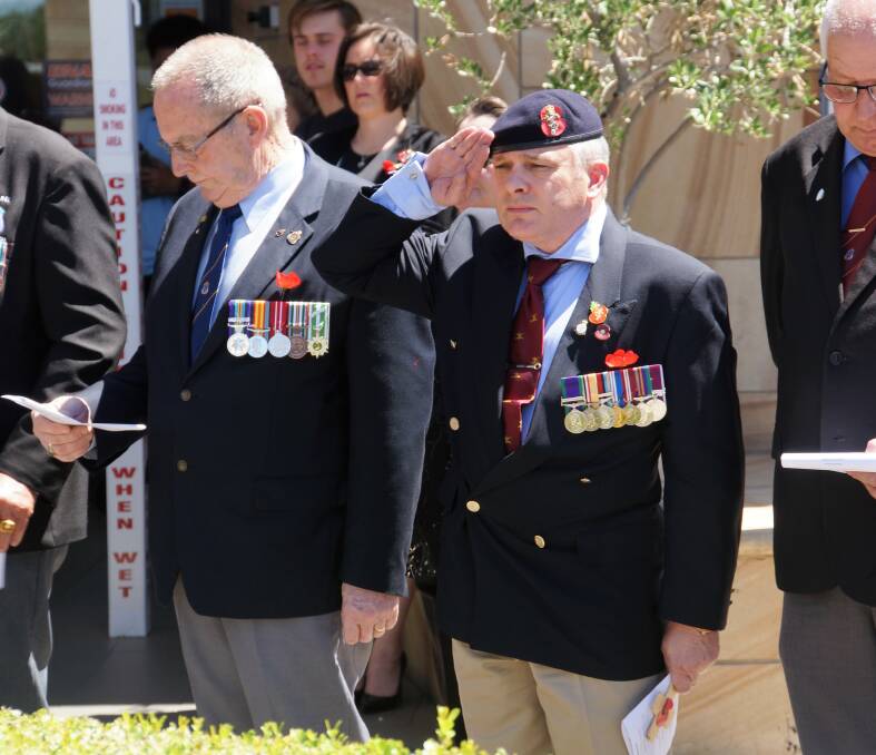 REMEMBERING THE SACRIFICE: Mark Armstrong pays tribute to fallen soldiers during last year's Remembrance Day service.