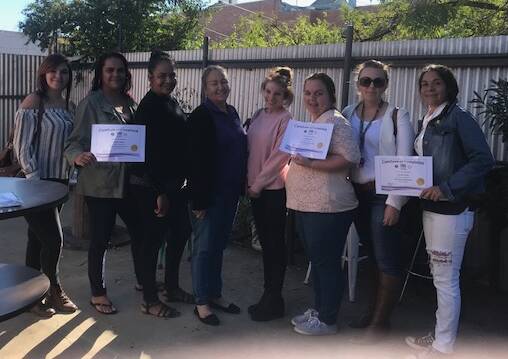 Staying Home Leaving Violence case managers Carol French (fourth from left) and Michelle Tansey (second from right) with the graduates Hayleigh Rose, Jennifer Whitton, Belinda Nixon, Madeline Russell, Sophie Moore and Carolyn Porter.