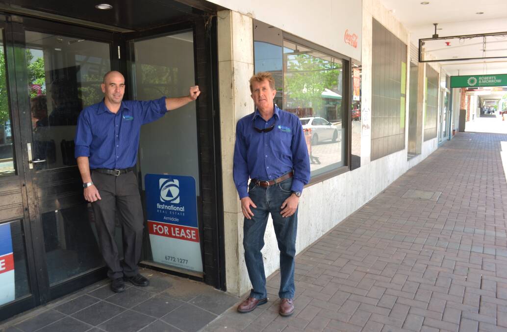 BUSINESSES ARE HURTING: RDANI executive director Nathan Axelsson and senior research economist David Thompson in front of an empty Armidale shopfront, typical of the wider region.