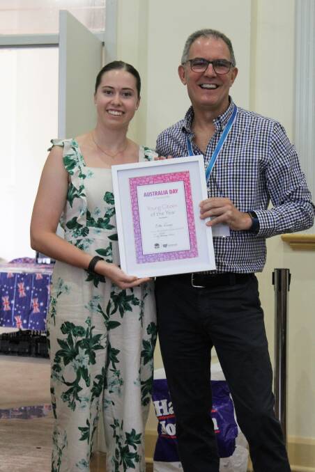Elka Devney accepts the Young Person of the Year award from Australia Day ambassador Clyde Campbell.