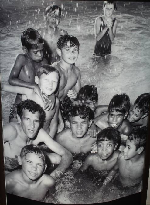 Charlie Perkins (left) pictured in the pool with the group of Aboriginal children, including an 11-year-old Wayne Nean (top, third from left). This photo forms part of the Dhiiyaan Aboriginal Centre's collection, which is currently featured in the 'Years of Knockbacks' exhibition celebrating the 55th anniversary of the Freedom Rides.