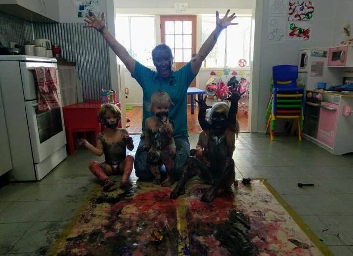 Rebecca Ellison pictured playing with her daycare children. Photo: contributed