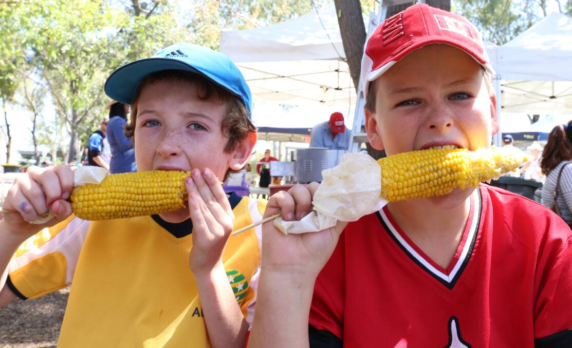 DELICIOUS: There will be a smorgasbord of delicious food options to tantalise the taste buds at St Philomena's Spring Fair next month. Pictured is Ned Farrell and Callum Ward taking advantage of the numerous food stalls at last year's event.