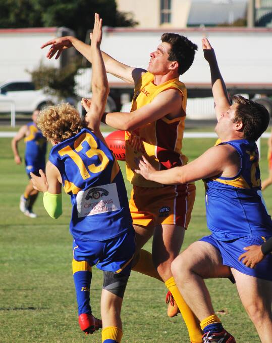 ON THE MARK: Moree's Paddy Montgomery fights for the ball against Narrabri players in an earlier clash between the two sides. Photo: Haley Caccianiga