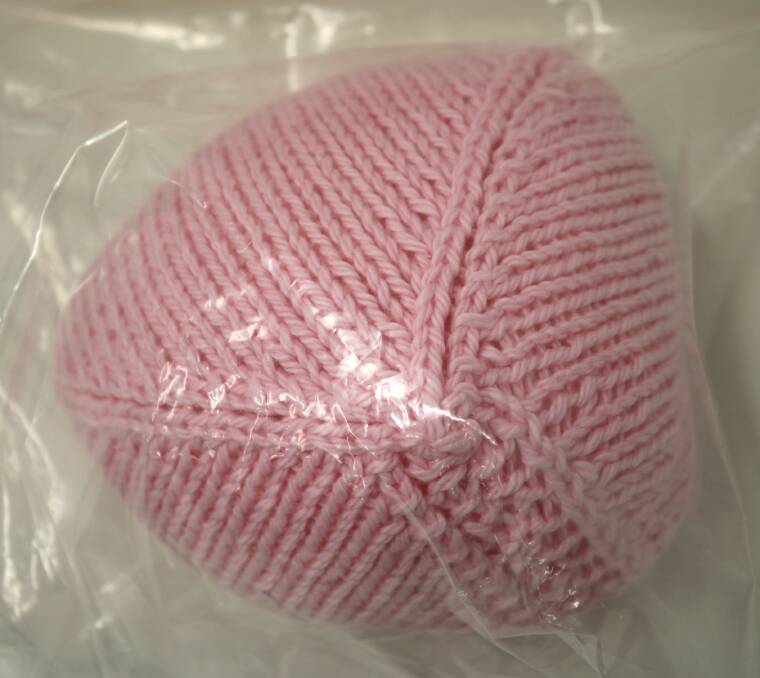 An example of a knitted knocker. The cotton prosthetics are placed in individual bags so they can be sent to cancer units for breast cancer patients.