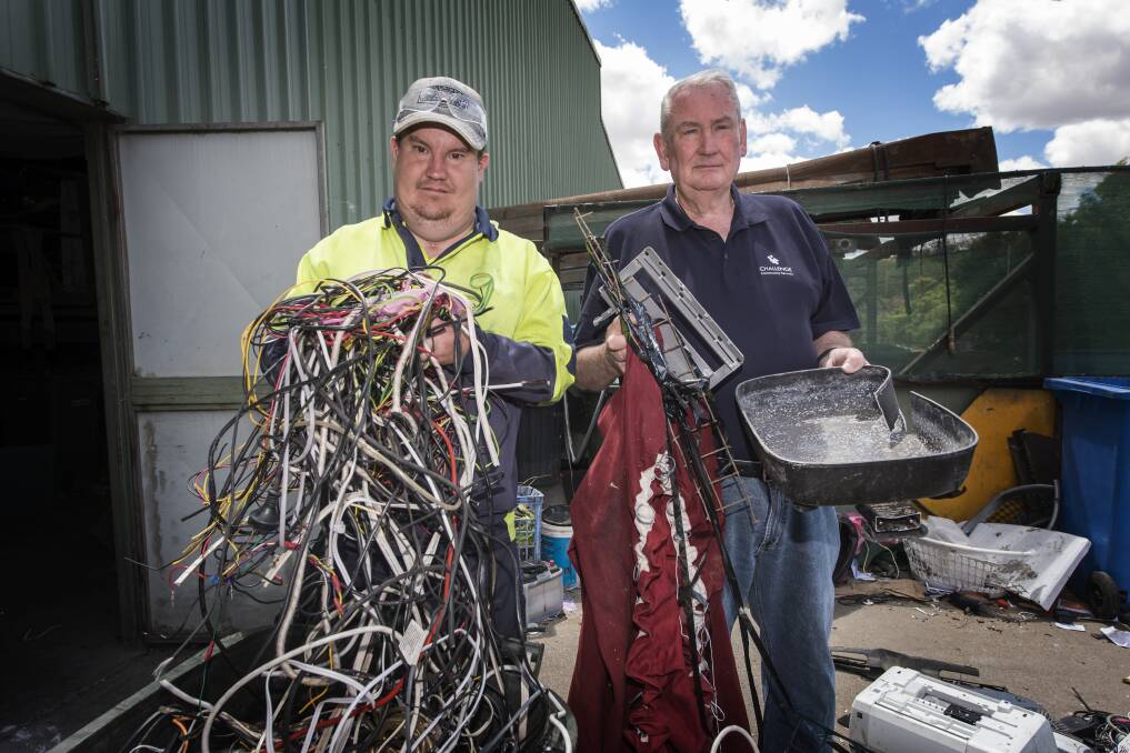 Think then throw: Challenge forklift operator Roly Caterer and CEO Barry Murphy show a few items of contamination found in household recycling bins. Photo: Peter Hardin.