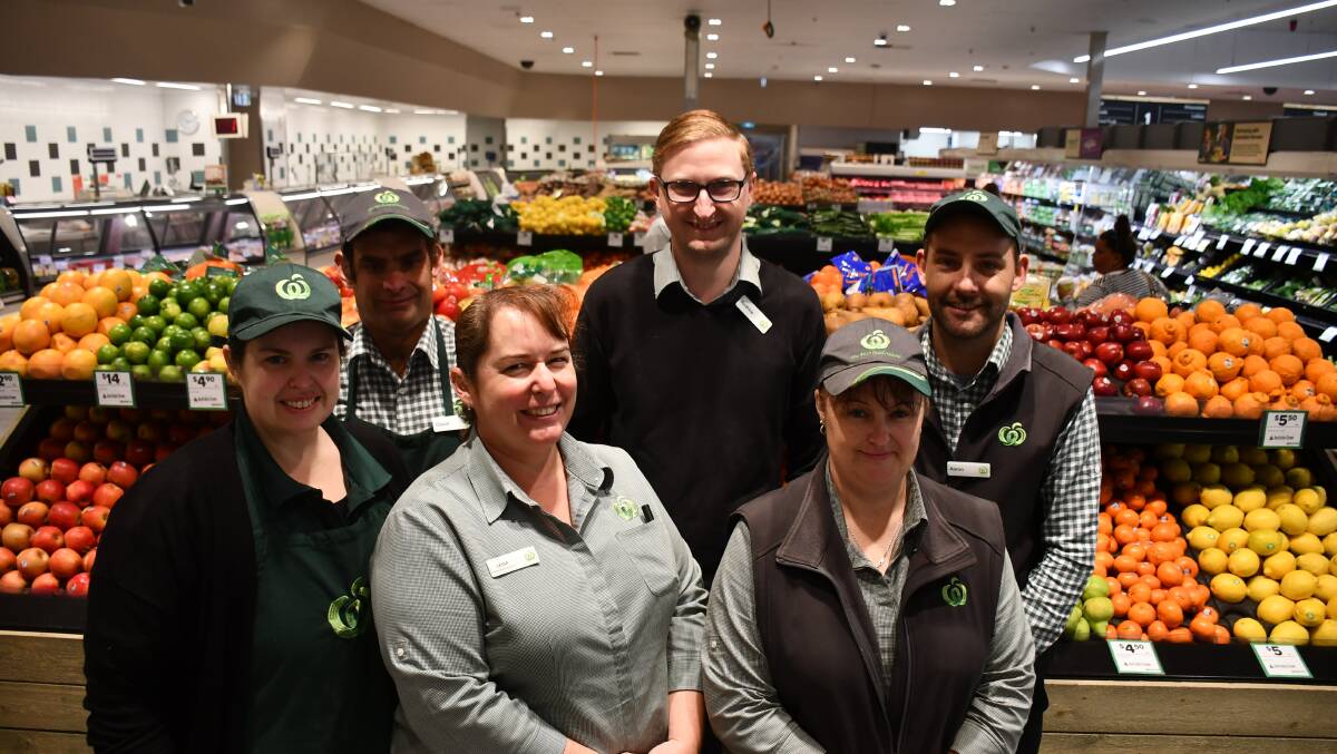 SATURDAY SHOP: Woolworths workers flank Moree Woolworths store manager Andrew Finch.