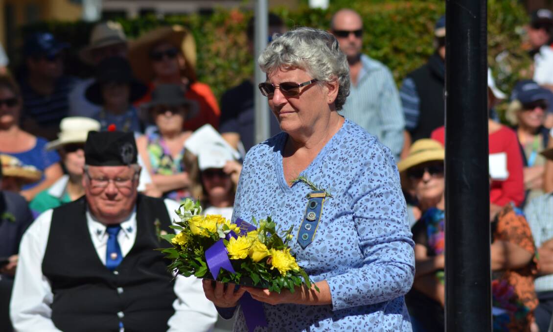 A woman lays a wreath at the Anzac Day ceremony held last year. 