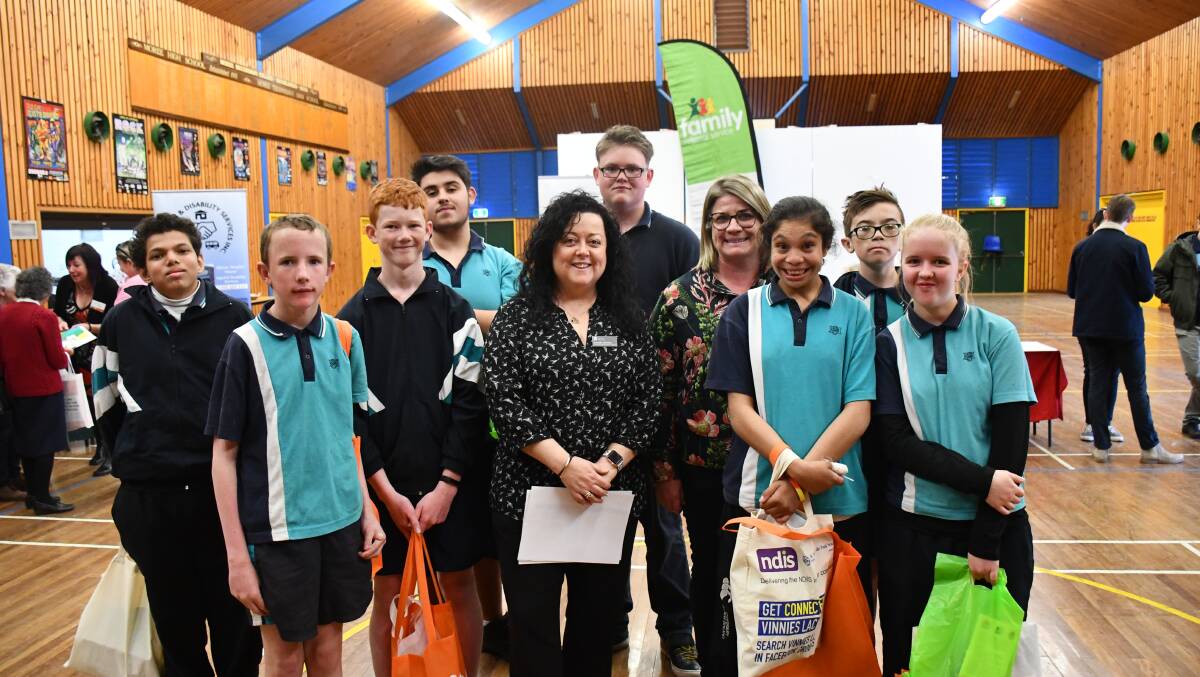 Moree Secondary College students surround Department of Education for New England Area transition support teacher Danielle Northey and Moree Secondary College head teacher of special education Ros VanDongen.