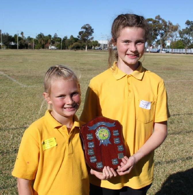 Bellata Sports Captains Allira Stolzenberg and Ruby Stewart with the Perpetual Winners Trophy.