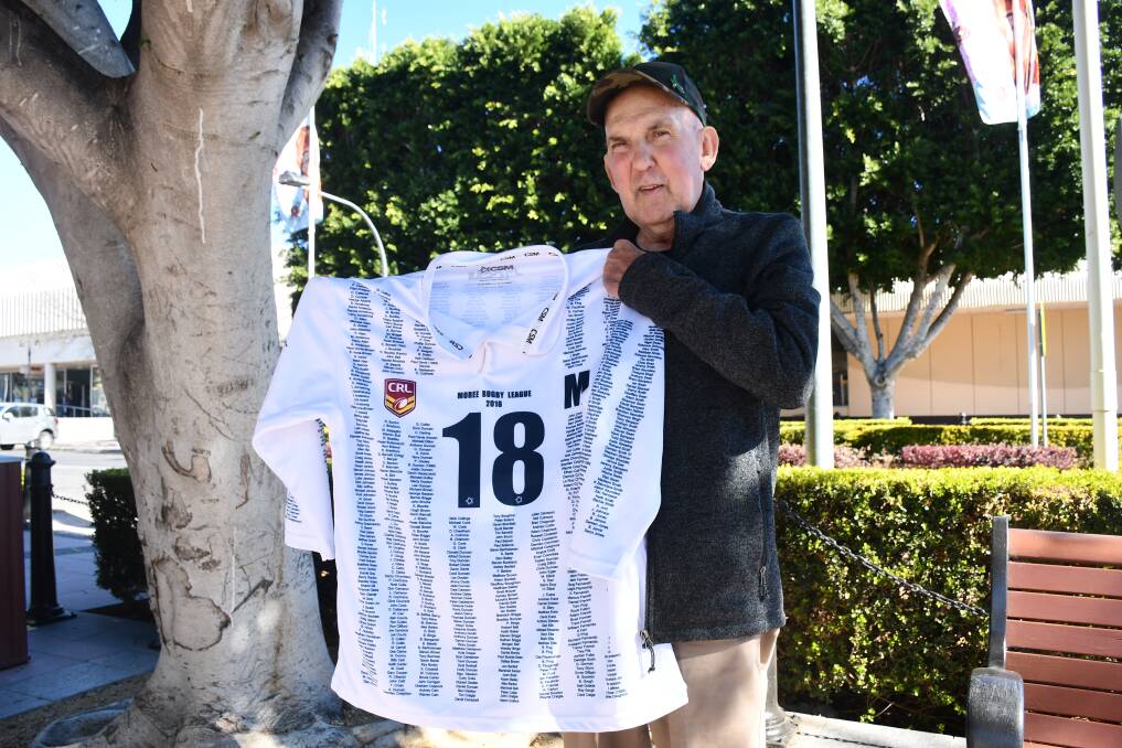Men of League secretary Tony Woodham showcases the guersney to be auctioned at the Boars v Hawks showdown.